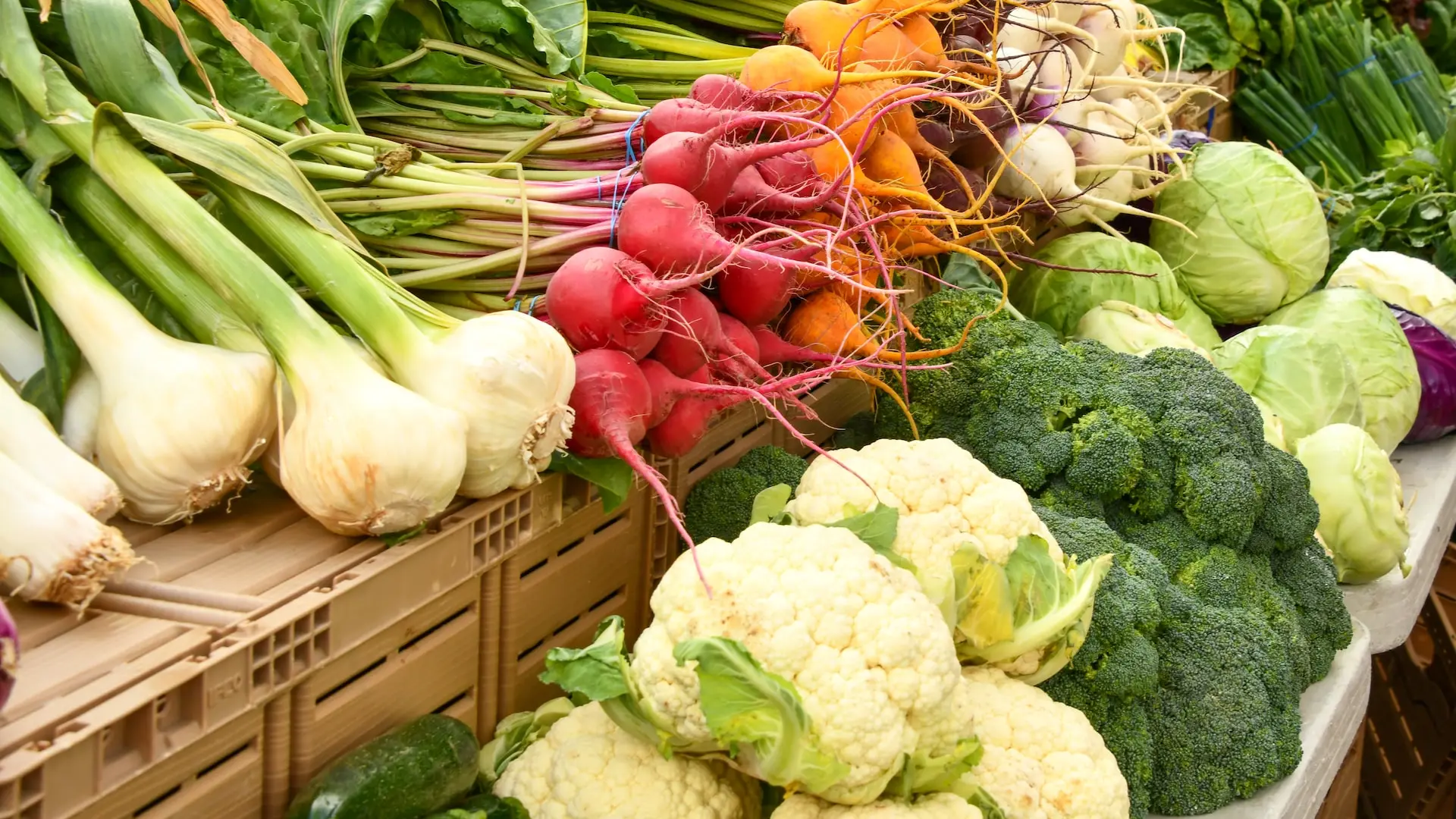 green and red vegetable on brown wooden table