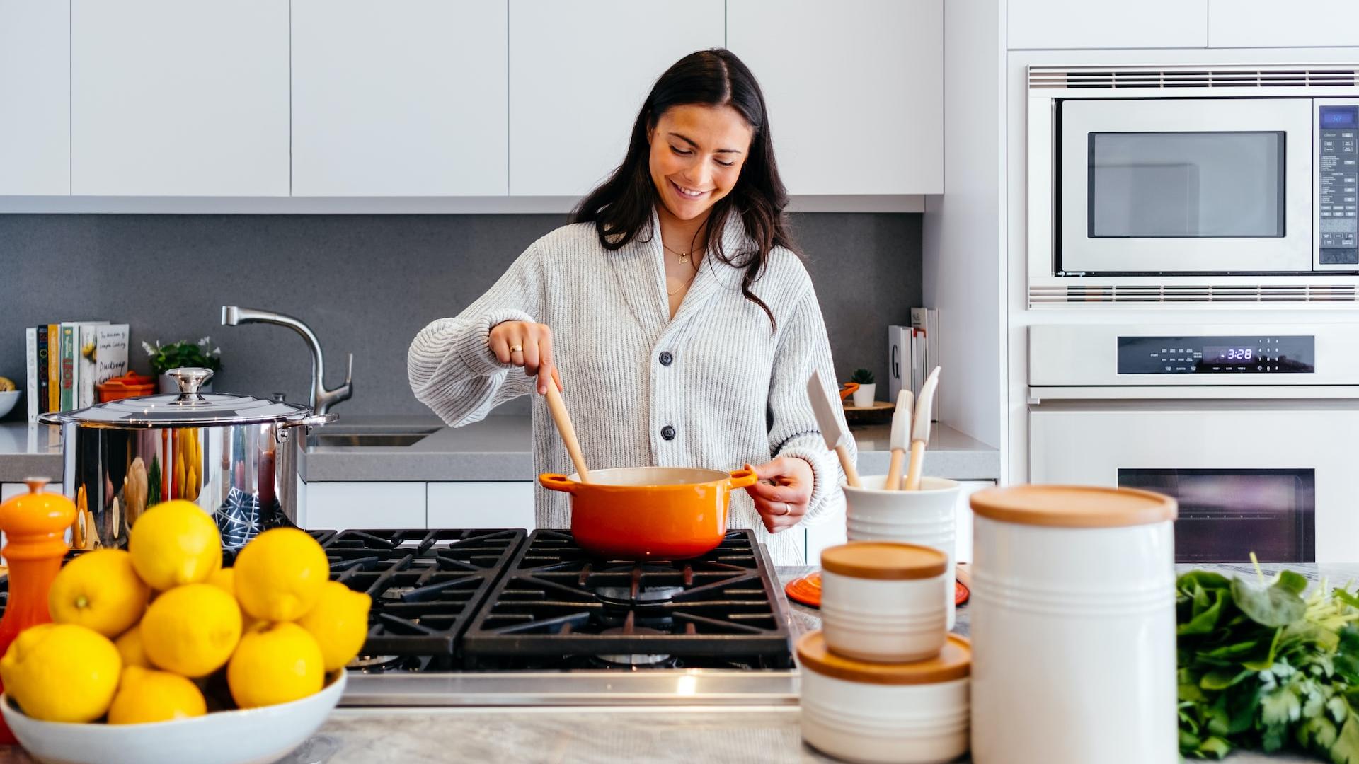 woman cooking inside kitchen room